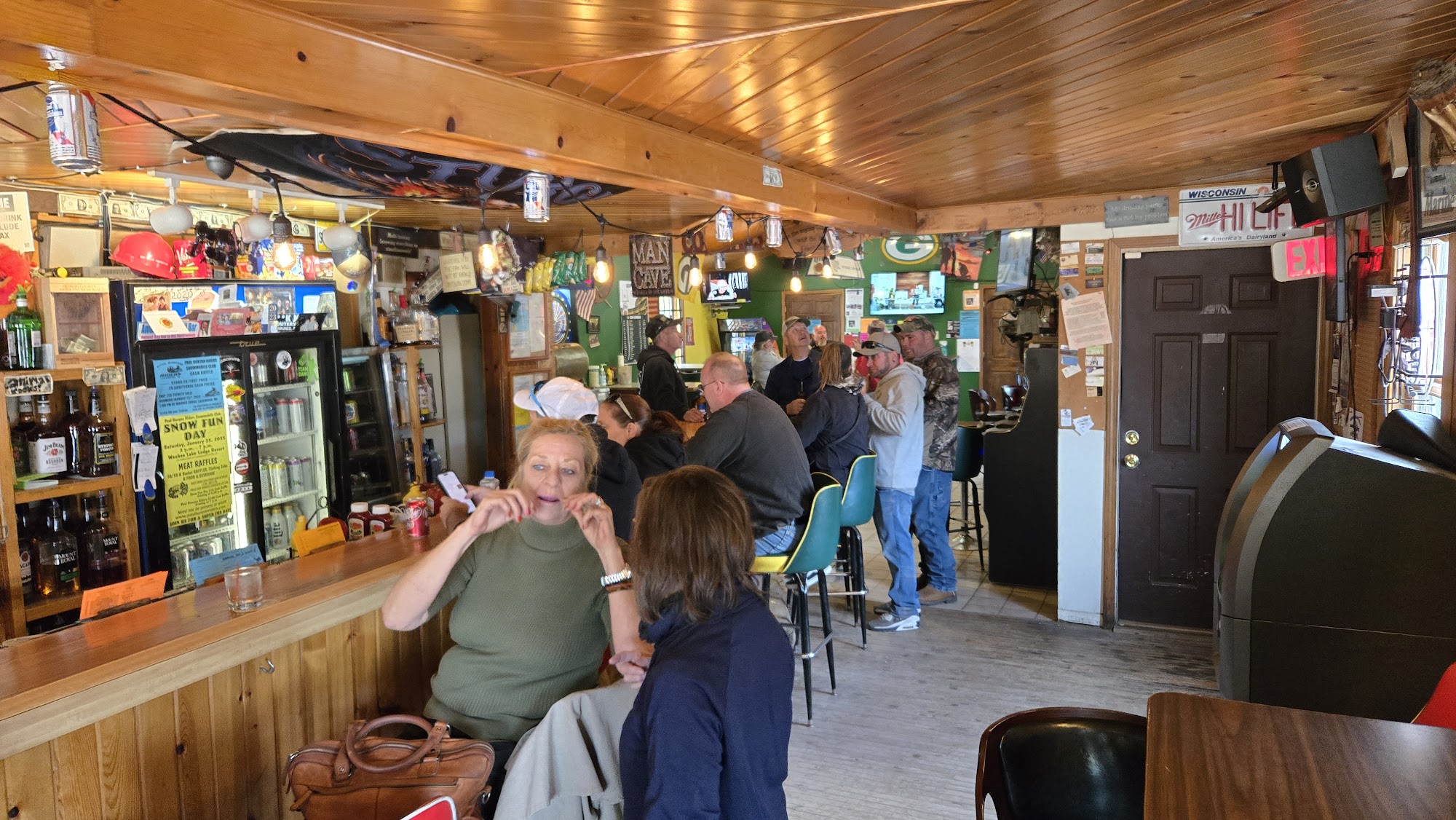 The warm, wood-paneled bar at Animal's Bear Trail with guests gathered inside