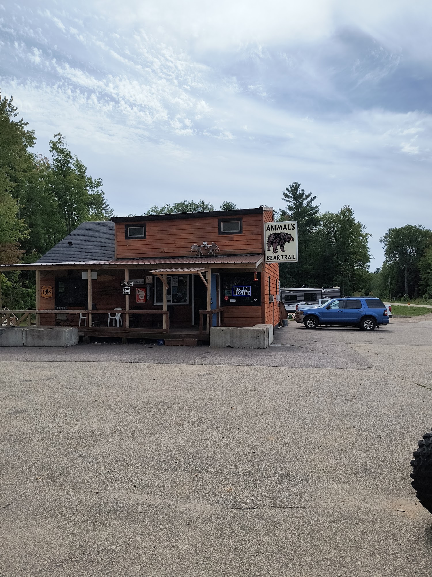 The rustic wood exterior and bear sign at Animal's Bear Trail
