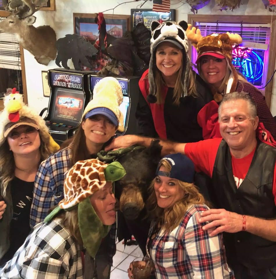 Friends in animal hats having fun together inside Animal's Bear Trail