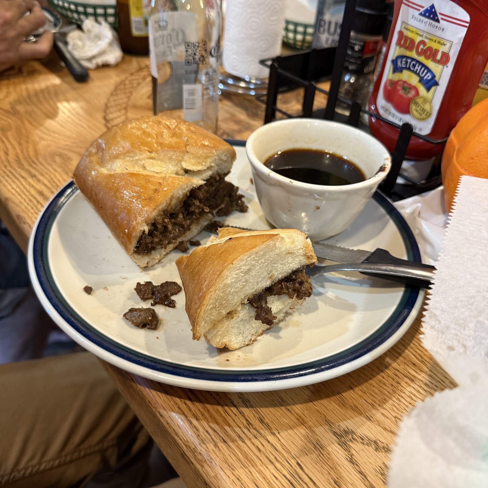 A hearty French dip sandwich and au jus served at the bar